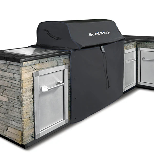 Outdoor kitchen with a grill cover on a stone wall background