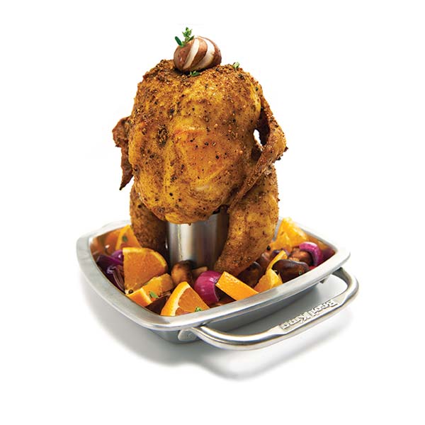 Roasted chicken on a rotisserie with vegetables on a white background